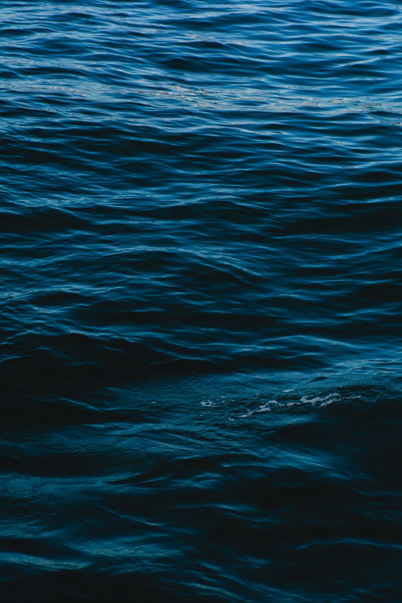 a man riding a surfboard on top of a body of water
